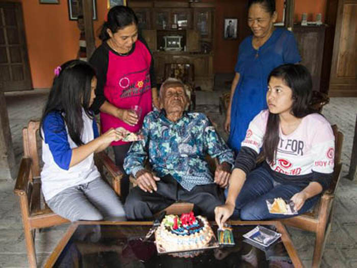 Mr Gotho celebrated the landmark birthday with his grandson, Suryanto, and his wife, Suwarni with their children Erika Kurniawati and Anisa Kurniawati (Donal Husni/ZUMA Wire/REX/Shutterstock)