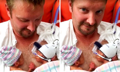 premature twins hold handsin father chest