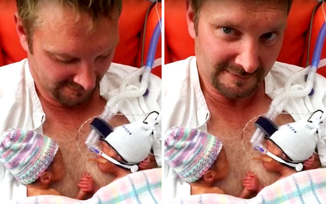 premature twins hold handsin father chest