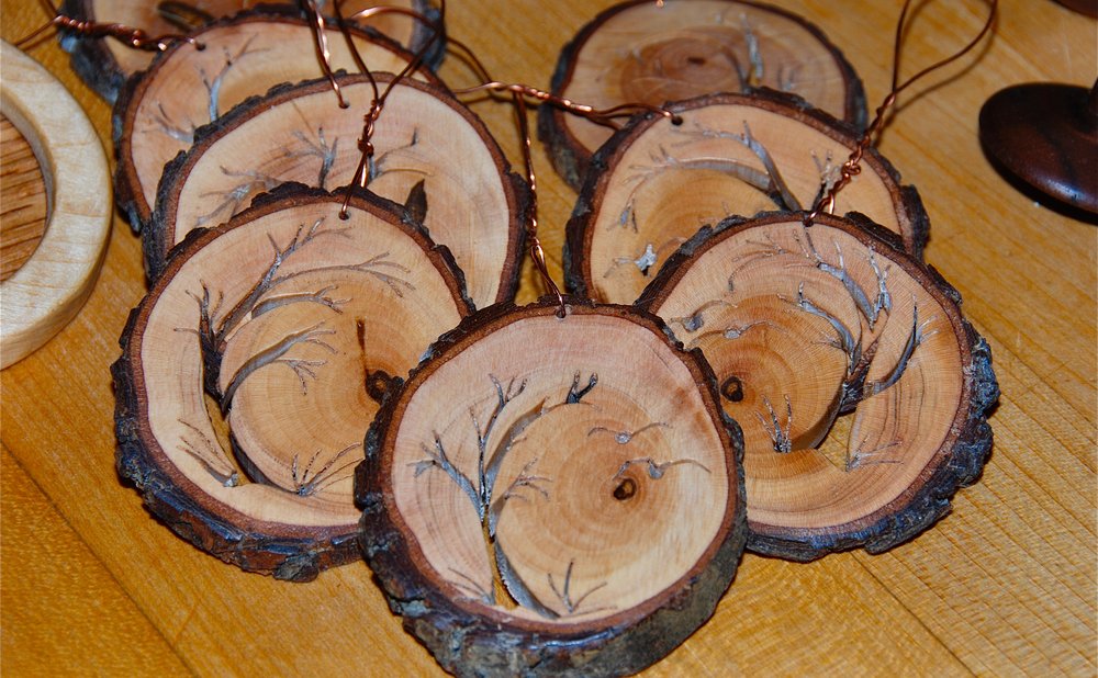 Painted wood slice Christmas ornaments hanging on a tree