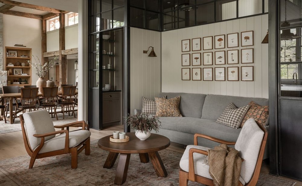 Gallery wall of framed botanical prints above a grey sofa