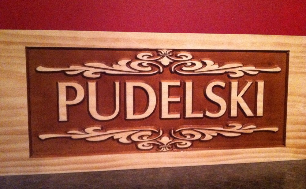 Rustic wood sign with stenciled lettering made from scrap boards
