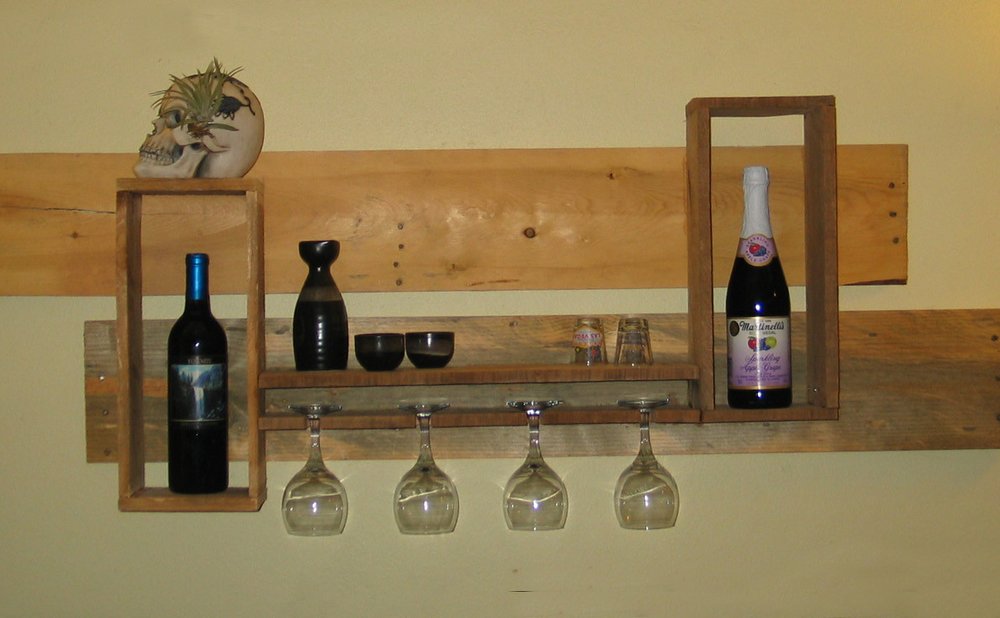 Small floating shelf made from reclaimed wood boards holding plants