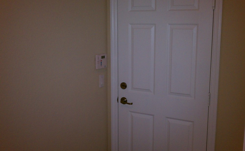 Weatherstripped door between an attached garage and the house