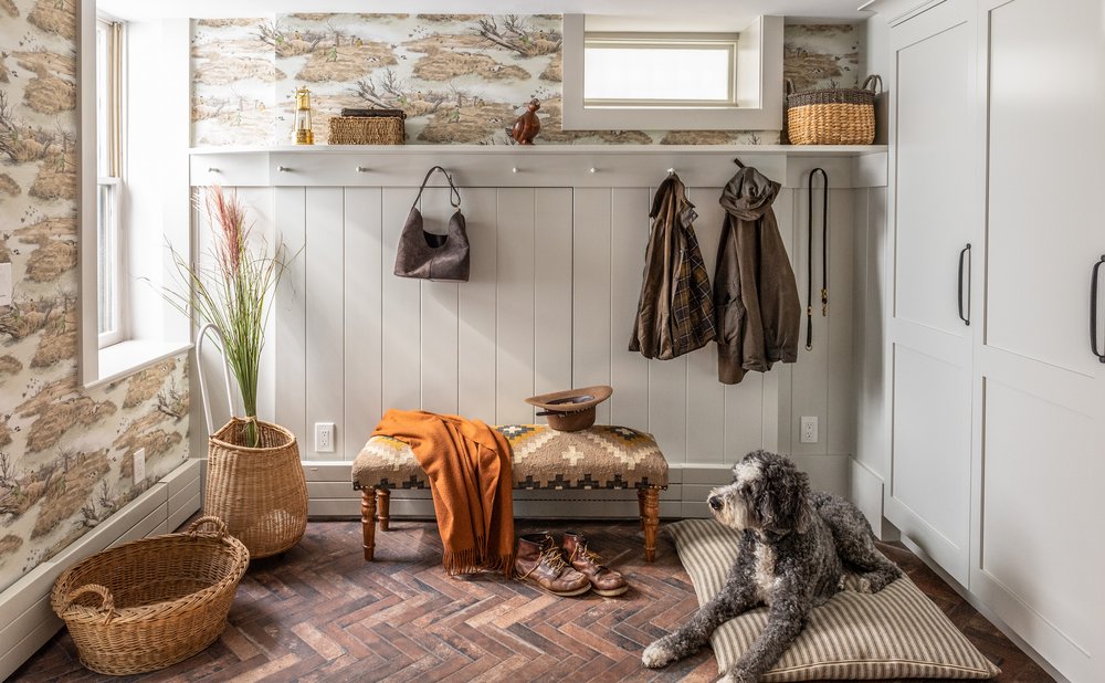 Mudroom with white beadboard walls, a peg rail and a wood bench