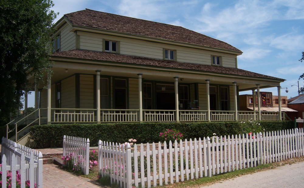 Tall two-story house with high gutters where a gutter cleaning pro is safer