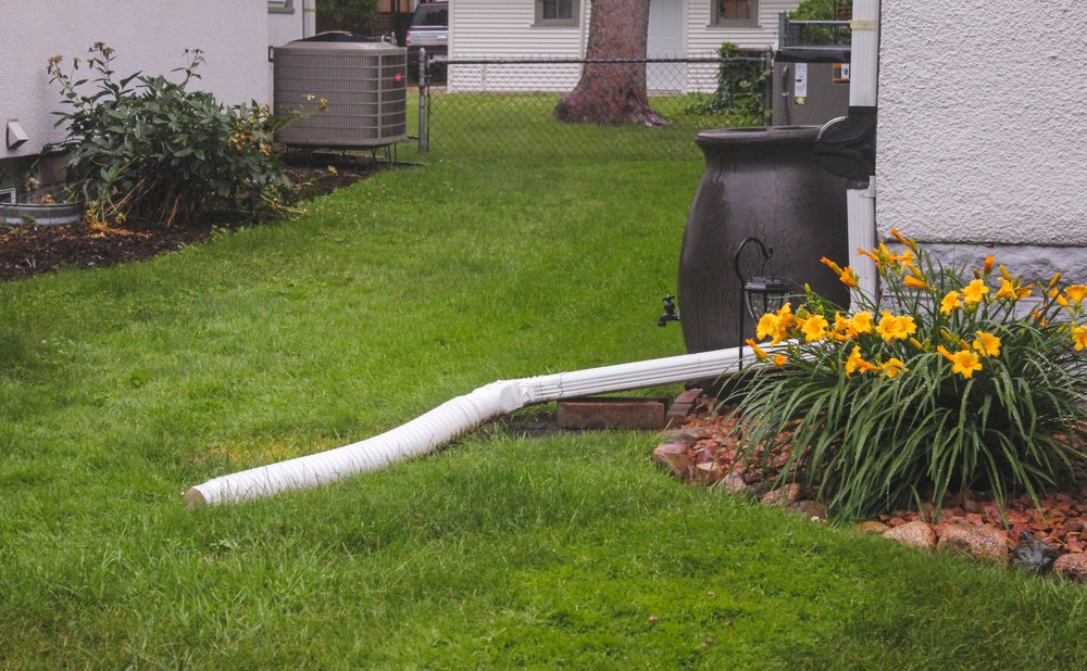 Downspout extension carrying roof water away from the house foundation