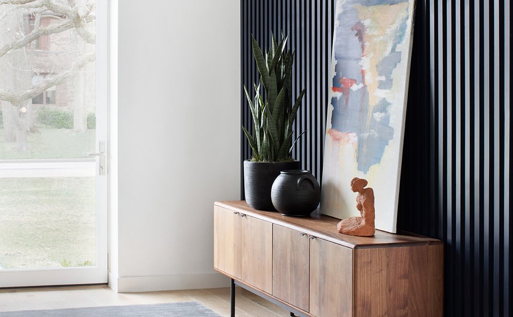 Walnut mid-century credenza with pottery and abstract art