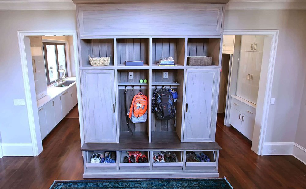 Mudroom charging station in a drawer with a wall-mounted mail sorter above