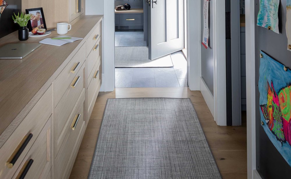 Washable indoor-outdoor runner in plain gray on a mudroom tile floor