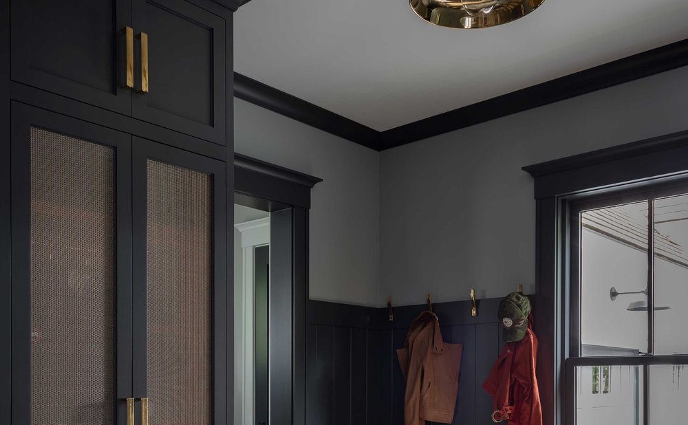 Mudroom lighting with two black flush mount fixtures over a bench and lockers