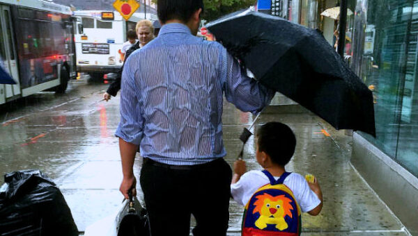 daddy drench rain holding umbrella to son viral online